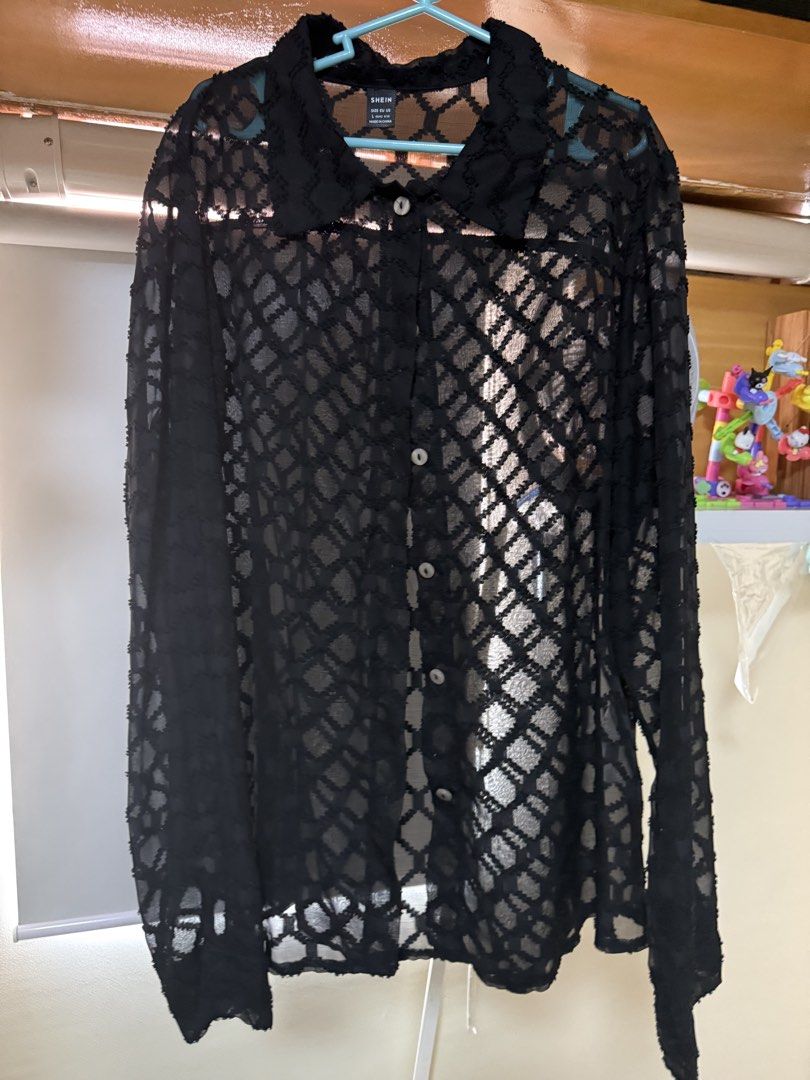 SHEIN Black Mesh Long Sleeve Button Up Shirt (Category: Longsleeves) located in Quezon City. Submitted by keyroline (Listing ID 1450562869, Image 1). Description: - SHEIN black mesh shirt - Size: L - Long sleeves - Button-up front - Collar neckline - Unique all-over diamond pattern - Versatile for layering or wearing solo.