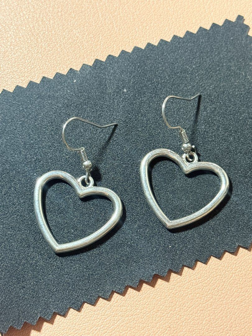 Silver Stainless Steel Heart Dangle Earrings (Category: Earrings) located in Manila. Submitted by thriftchic__ (Listing ID 1450631880, Image 1). Description: - Cute silver heart-shaped earrings - Simple and classic design - Great for everyday wear - Lightweight and comfortable - Easy to put on and take off - Silver stainless steel.