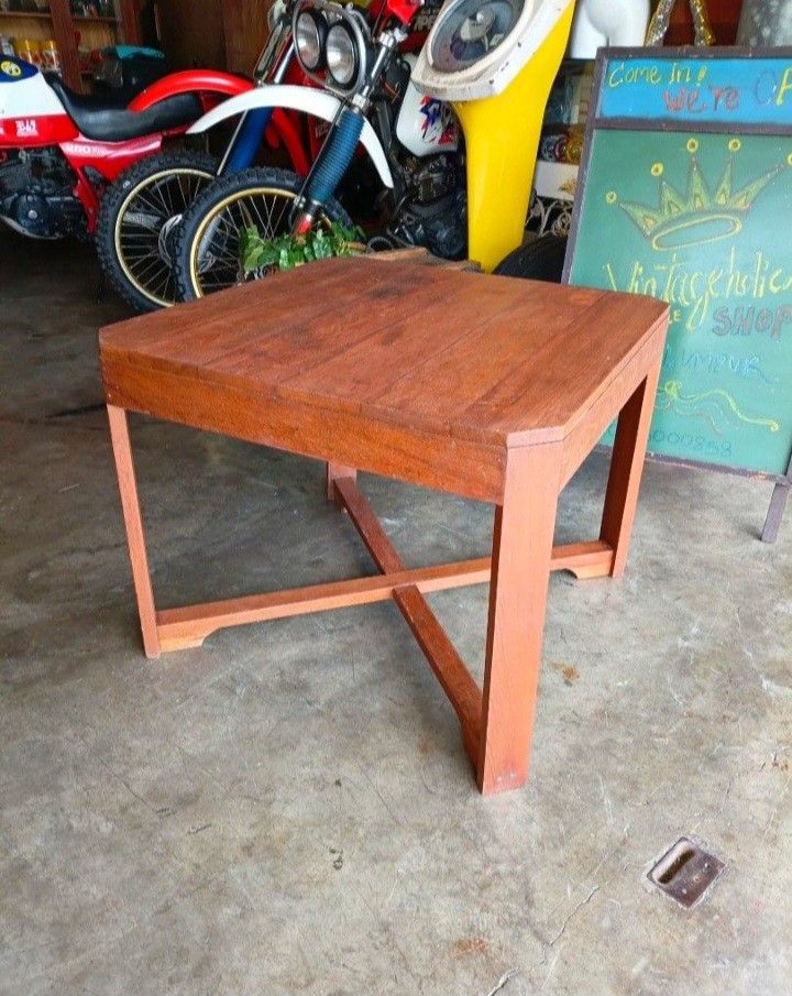 Solid Wood Side Table / Coffee Table (Category: Tables & Sets) located in Shah Alam. Submitted by jamie9collector (Listing ID 1450733043, Image 3). Description: - Mid Century Modern Teak Coffee Table - Warm, inviting wood tone - Versatile: use as a coffee table or side table - Sturdy construction with cross leg support - Approximate height: 22 inches - Surface shows minor wear consistent with normal use - Ready for its new home!.