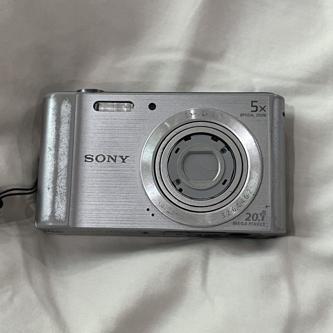 Sony Cybershot DSC W800 Digital Camera Digicam (Category: Cameras) located in Iloilo. Submitted by aradeclutters (Listing ID 1442517692, Image 1). Description: Location: Iloilo Bought second-hand last December 2025 from FB marketplace. Condition: All buttons working Flash and video working Issues: - Lens curtain needs to be manually closed - Lens dust when zoomed - LCD line & black part (doesn’t affect output) Inclusions: unit, battery, memory ca