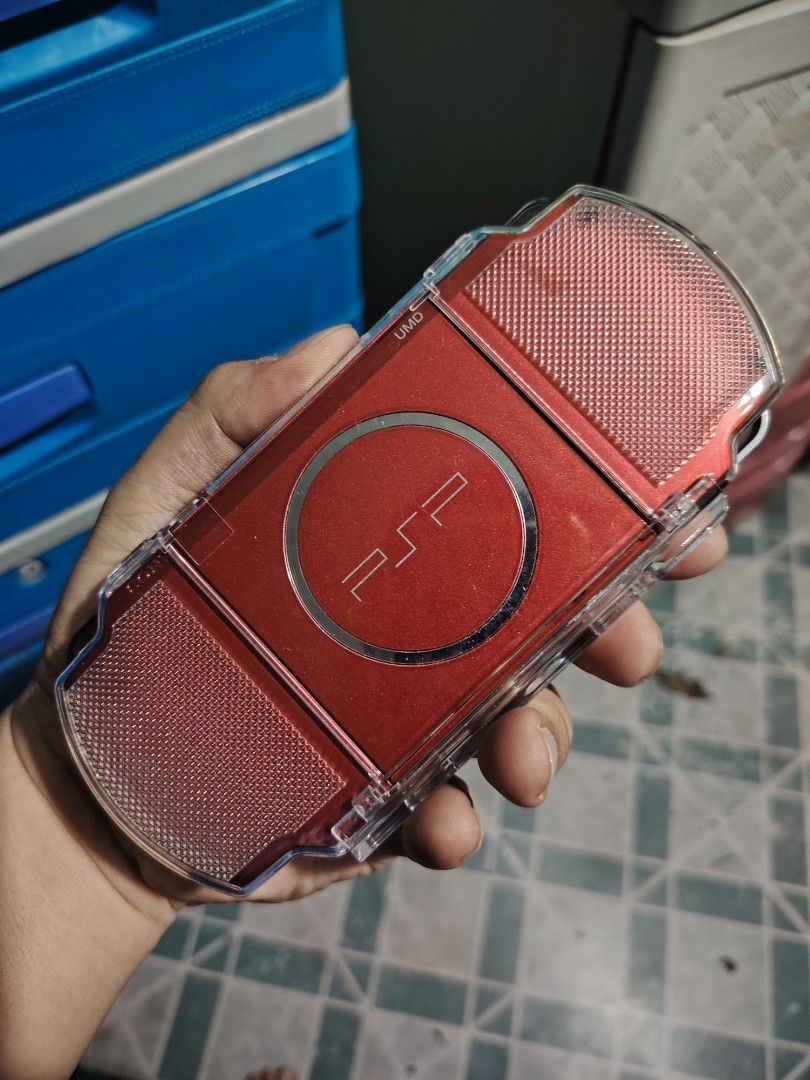 Sony PSP 3000 Red Handheld Console (Category: Others) located in Manila. Submitted by lemsgadgetszone (Listing ID 1450658944, Image 2). Description: - Red Sony PSP 3000 - Comes with a clear protective case - Screen is clean and scratch-free - Buttons and D-pad are in excellent working condition - Ideal for gaming on the go - Ready for a new owner.