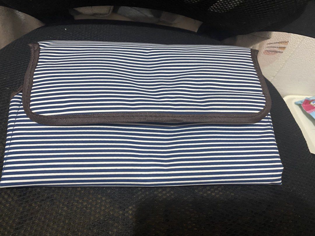 Striped Portable Baby Changing Pad Mat (Category: Changing Mats & Accessories) located in Las Pinas. Submitted by allaroundseller (Listing ID 1450643003, Image 2). Description: - Blue and white striped design - Folds neatly for convenient travel - Features a soft tan interior lining - Includes a strap for secure closure - Perfect for on-the-go diaper changes - Easy to wipe clean for hygiene.