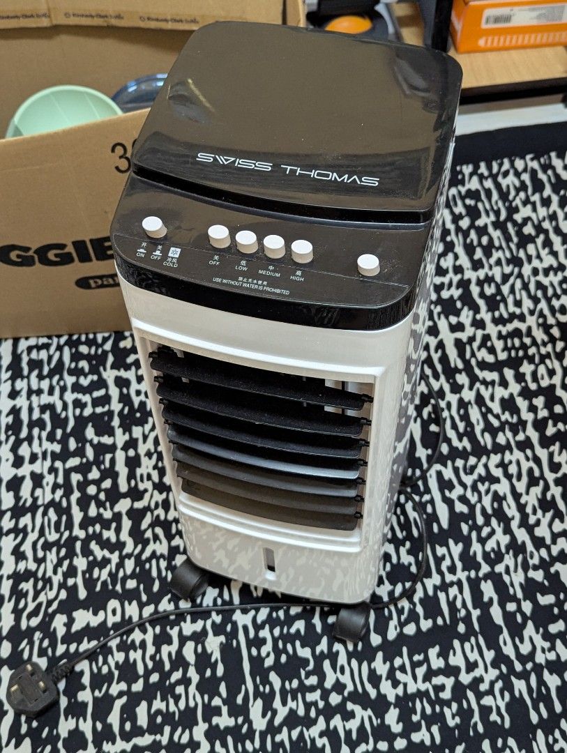 Swiss Thomas Air Cooler with Wheels (Category: Air Conditioners & Heating) located in Kuala Lumpur. Submitted by honeys__ (Listing ID 1450560914, Image 1). Description: - Swiss Thomas Air Cooler - Easy mobility with wheels - Convenient top panel controls - Adjustable front vents for directional cooling - Effectively cools down any room - Comes with power cord.