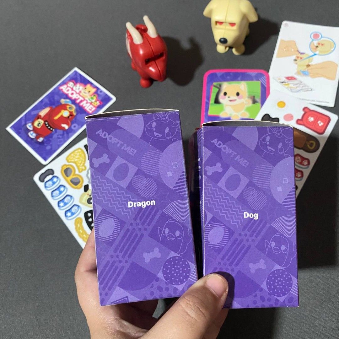 Take All Mcdo Adopt Me (Category: Designer & Blind Box Toys) located in Quezon City. Submitted by desuriia (Listing ID 1450557952, Image 2). Description: Adopt Me Dog and Dragon Both for P200 -All Intact (stickers/card game) - Dog - Dragon RFS: Decluttering Loc: Sikatuna Bliss QC (Pick-up/Lalamove Only).