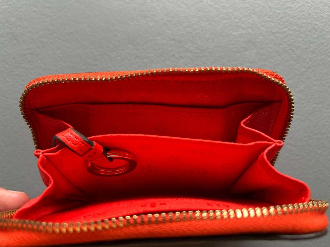 Tory Burch Red Leather Coin Pouch Wallet (Category: Luxury Bags & Wallets) located in Calamba. Submitted by merrymerida (Listing ID 1450597454, Image 2). Description: - Bright red Tory Burch coin pouch - Genuine leather with embossed logo - Secure zipper closure - Interior card slots for organization - Cute tassel detail on zipper pull - Ideal for keeping small essentials tidy.
