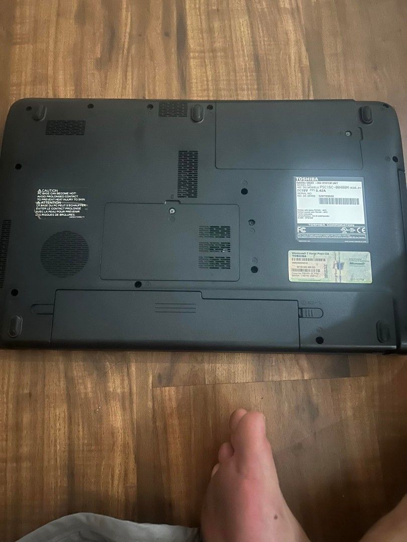 Toshiba Laptop (Category: Laptops & Notebooks) located in Manila. Submitted by medranoge72238 (Listing ID 1450606639, Image 2). Description: - Toshiba laptop - Sleek black exterior - Ports and ventilation visible on bottom - unit ( for parts).