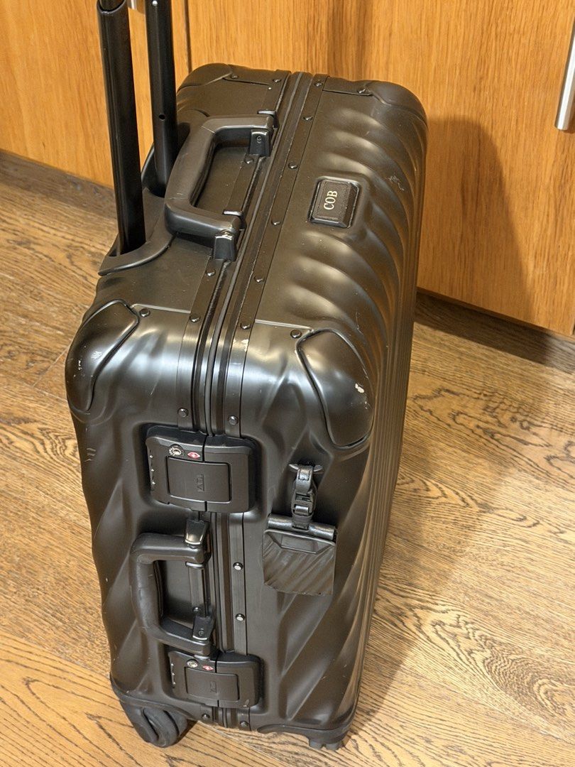 Tumi Black Hard Shell Carry-On Luggage (Category: Luggage) located in Makati City. Submitted by coterba (Listing ID 1450705698, Image 2). Description: - Brand: Tumi - Color: Black - Type: Hard Shell Carry-On - Features: TSA-approved locks, retractable handle, four spinner wheels - Condition: Minor scuffs from normal travel - Personalization: Includes a tag that says 'COB'.