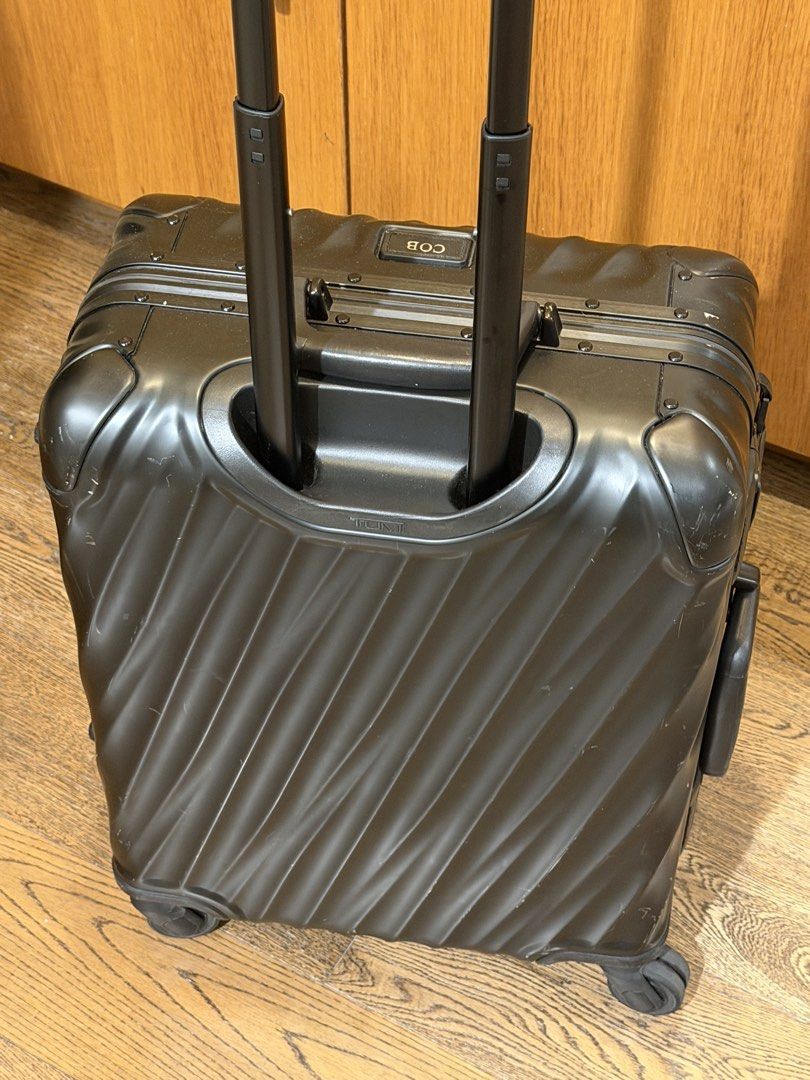 Tumi Black Hard Shell Carry-On Luggage (Category: Luggage) located in Makati City. Submitted by coterba (Listing ID 1450705698, Image 1). Description: - Brand: Tumi - Color: Black - Type: Hard Shell Carry-On - Features: TSA-approved locks, retractable handle, four spinner wheels - Condition: Minor scuffs from normal travel - Personalization: Includes a tag that says 'COB'.