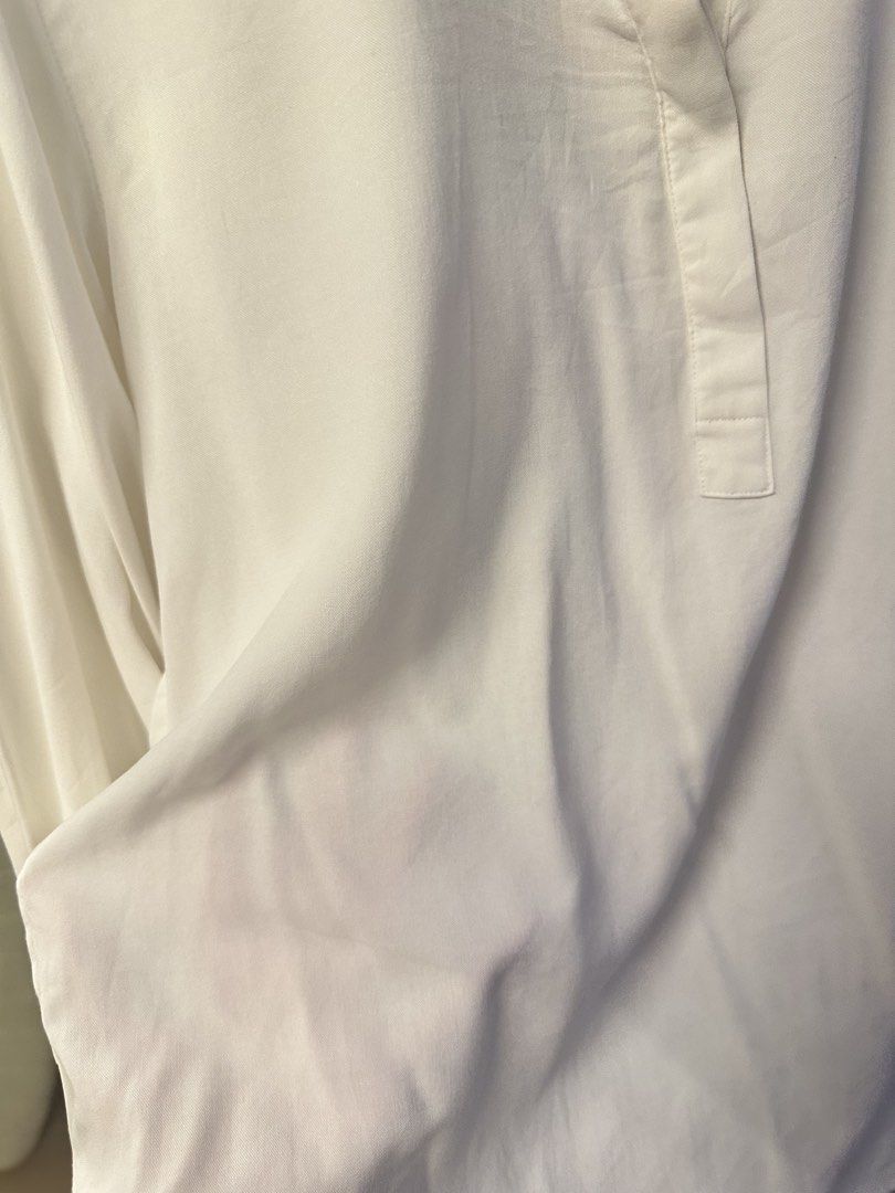 Uniqlo White Mandarin Collar Blouse (Category: Blouses) located in Malolos. Submitted by daniescloset (Listing ID 1450530300, Image 3). Description: - Uniqlo White Blouse - Mandarin collar with V-neck opening - Long sleeves with button cuffs - Material: Rayon-Polyester blend - Style: Perfect for casual or work attire With stain due to storage.