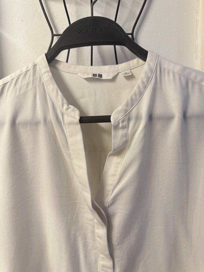 Uniqlo White Mandarin Collar Blouse (Category: Blouses) located in Malolos. Submitted by daniescloset (Listing ID 1450530300, Image 2). Description: - Uniqlo White Blouse - Mandarin collar with V-neck opening - Long sleeves with button cuffs - Material: Rayon-Polyester blend - Style: Perfect for casual or work attire With stain due to storage.