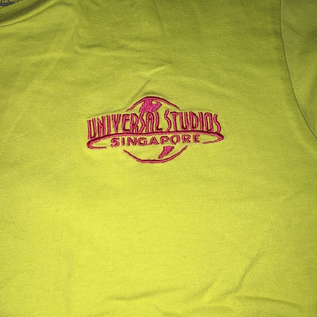Universal Studios Singapore embroidered green shirt (Category: Shirts) located in Manila. Submitted by danekb (Listing ID 1450709281, Image 2). Description: has small holes (see last pic) size L FLAT MEASUREMENTS: length - approx 26 inches width - approx 16 inches.