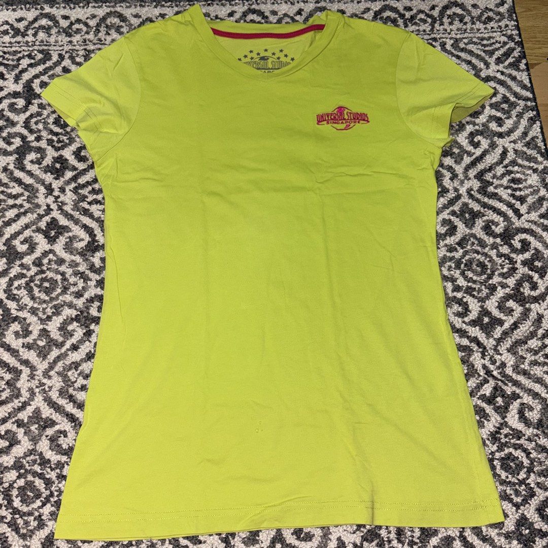 Universal Studios Singapore embroidered green shirt (Category: Shirts) located in Manila. Submitted by danekb (Listing ID 1450709281, Image 1). Description: has small holes (see last pic) size L FLAT MEASUREMENTS: length - approx 26 inches width - approx 16 inches.