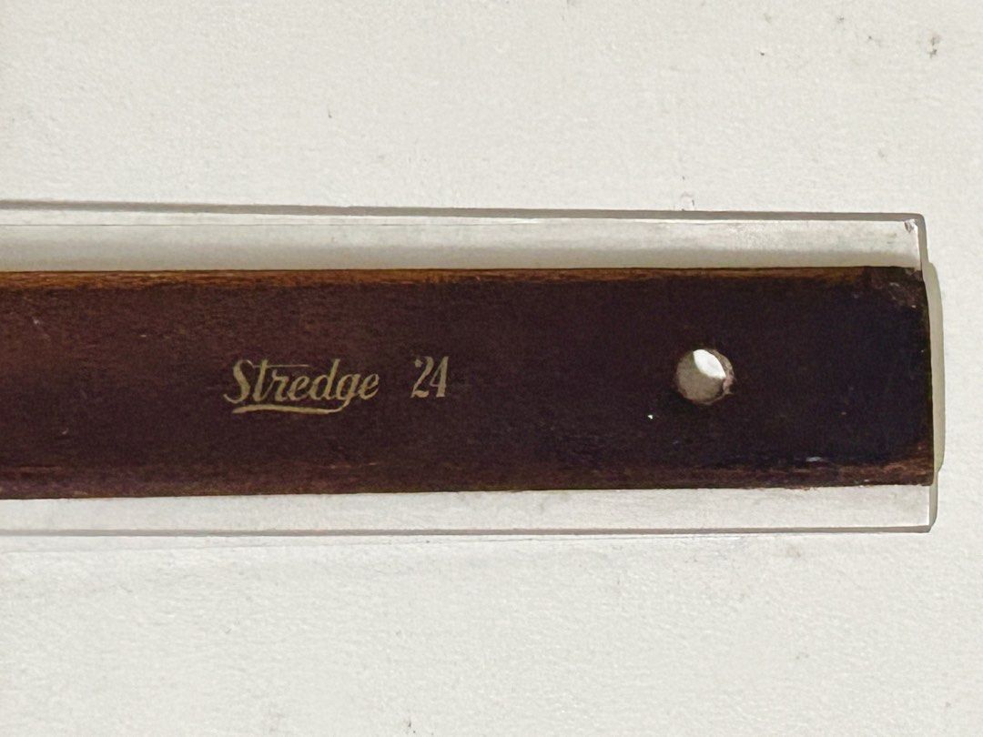 Vintage Stredge 24 T-Square Ruler (Category: Stationery & School Supplies) located in Las Pinas. Submitted by rjmwings (Listing ID 1450640544, Image 2). Description: Wooden T-square ruler. Marked 'Stredge 24'. Bought in 1983. Still in good condition. Has a dark head and a wooden handle. Clear plastic overlay on the ruler. Great for drafting or drawing straight lines. A classic tool for artists or architects..