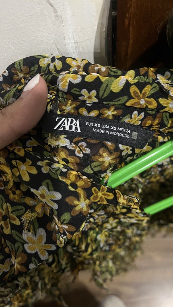 Zara Floral Sheer Button-Up Shirt (Category: Shirts) located in Pasig City. Submitted by kakerts (Listing ID 1450620245, Image 3). Description: - Zara sheer button-up shirt - Black base with yellow and white floral print - Long sleeves with fringe detailing on cuffs and hem - Button closure down the front - Lightweight and flowy material.