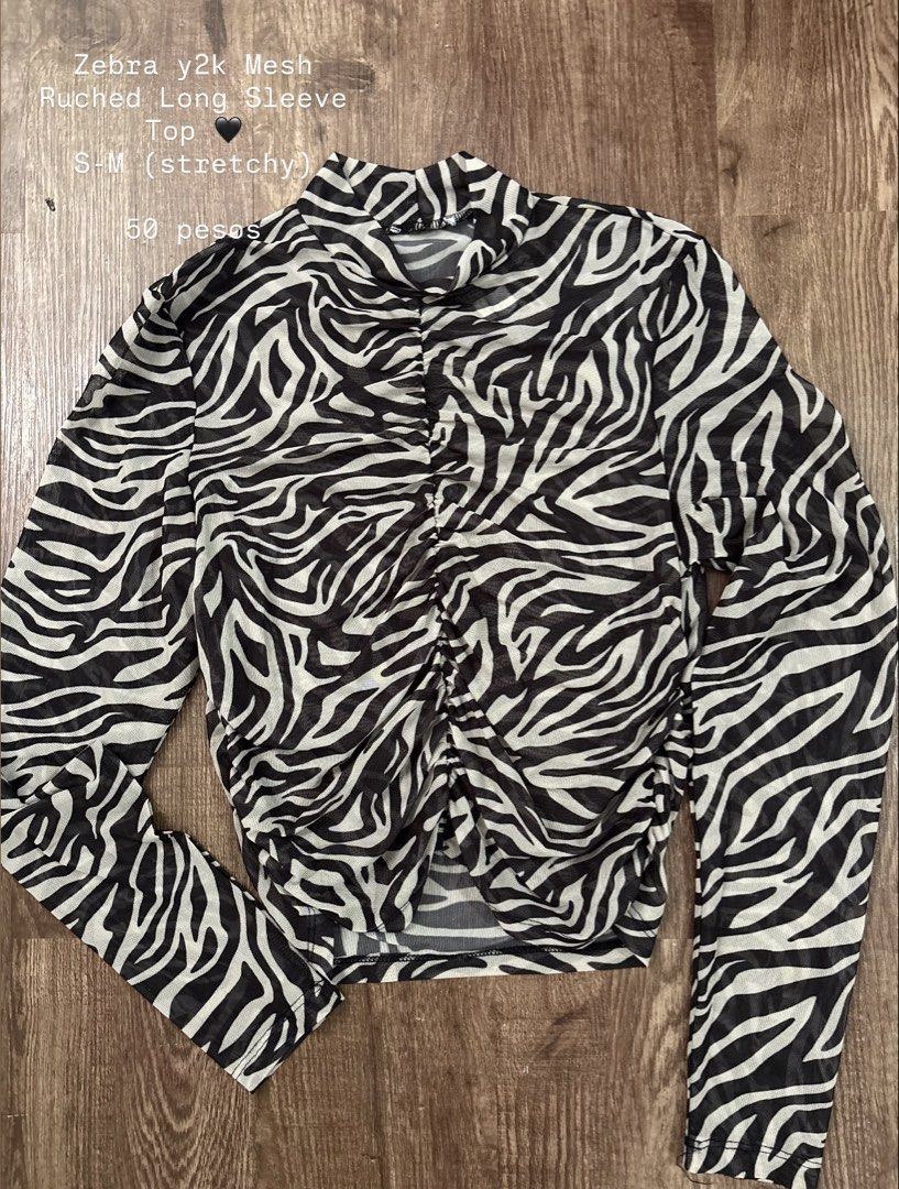 Zebra y2k Mesh Ruched Long Sleeve Top (Category: Longsleeves) located in Rizal. Submitted by decluttch (Listing ID 1450647593, Image 1). Description: Super cute zebra print mesh top. Y2k style with ruched detailing down the front. Long sleeves and a mock neck. Stretchy material, fits S-M. Great for layering or wearing on its own..