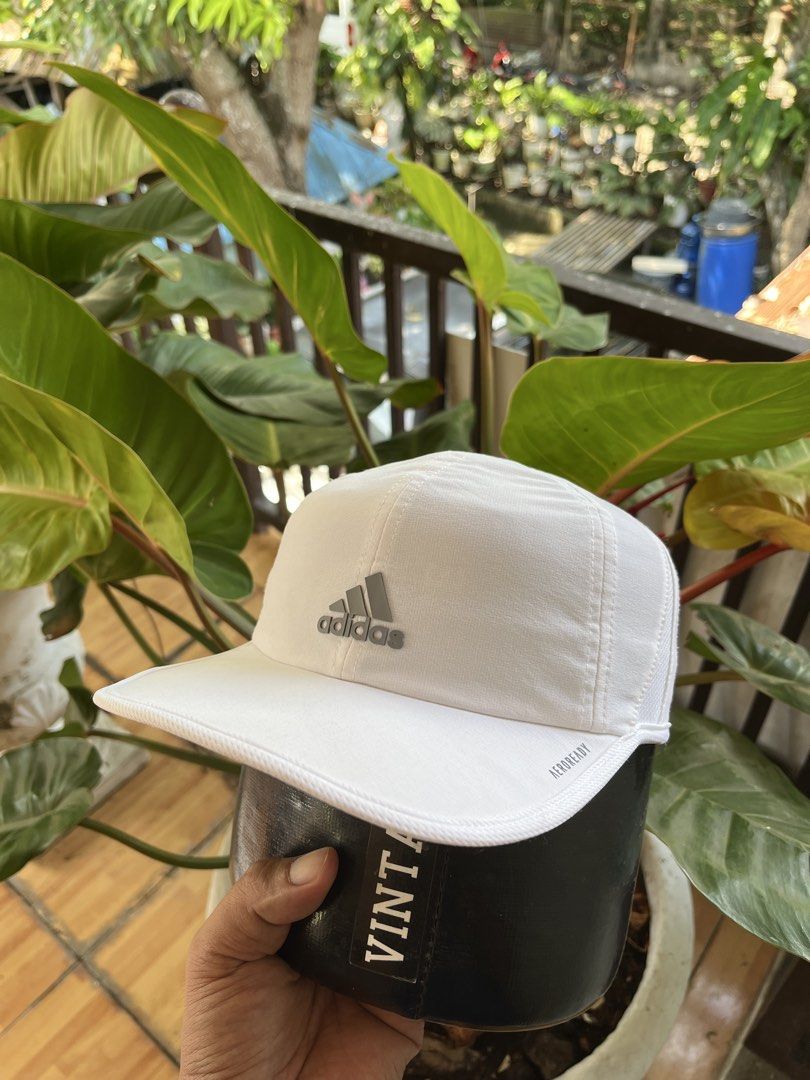 Adidas White running Cap Aeroready OSFW (Category: Caps & Hats) located in Tabuelan. Submitted by franzloyd181453 (Listing ID 1447150980, Image 2). Description: - Classic white Adidas cap - Features iconic Adidas logo on the front - Made with Aeroready material for breathability and cooling - Adjustable strap at the back for a customized fit - One size fits most.