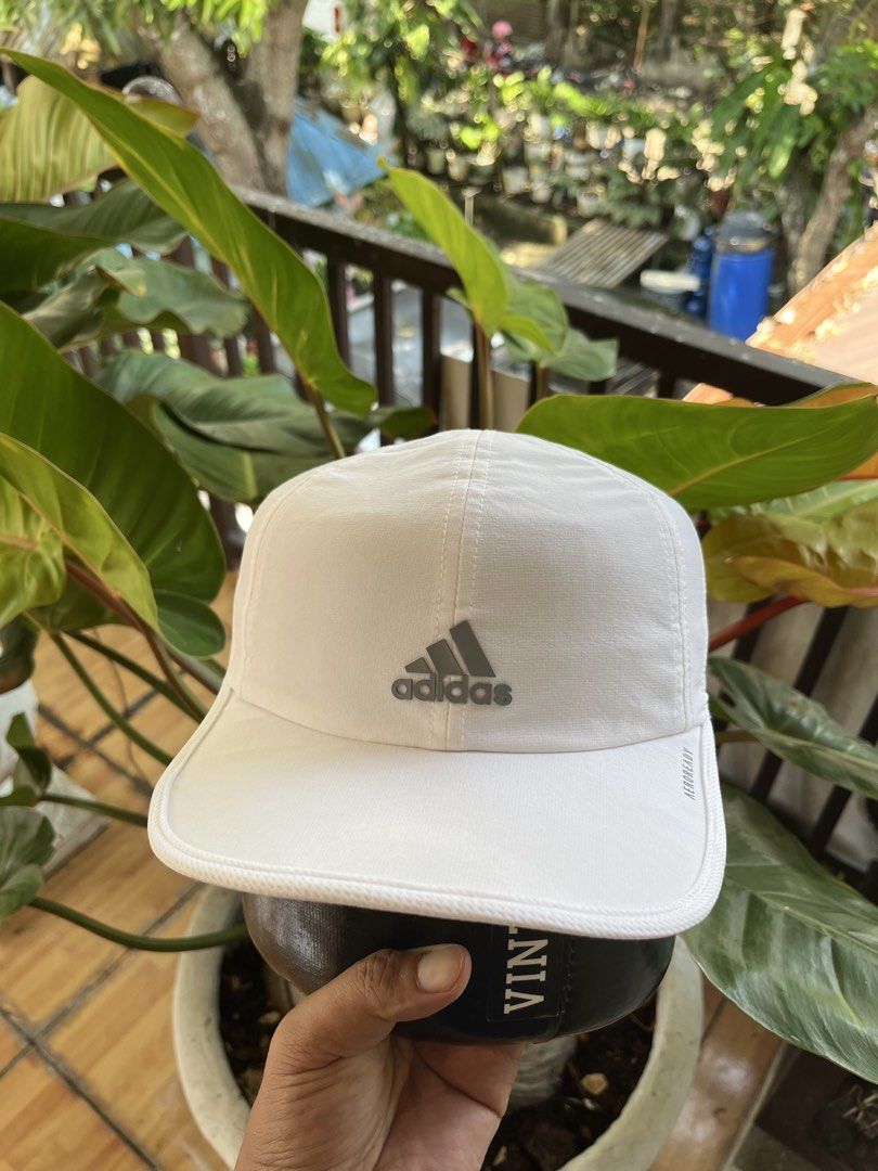 Adidas White running Cap Aeroready OSFW (Category: Caps & Hats) located in Tabuelan. Submitted by franzloyd181453 (Listing ID 1447150980, Image 3). Description: - Classic white Adidas cap - Features iconic Adidas logo on the front - Made with Aeroready material for breathability and cooling - Adjustable strap at the back for a customized fit - One size fits most.