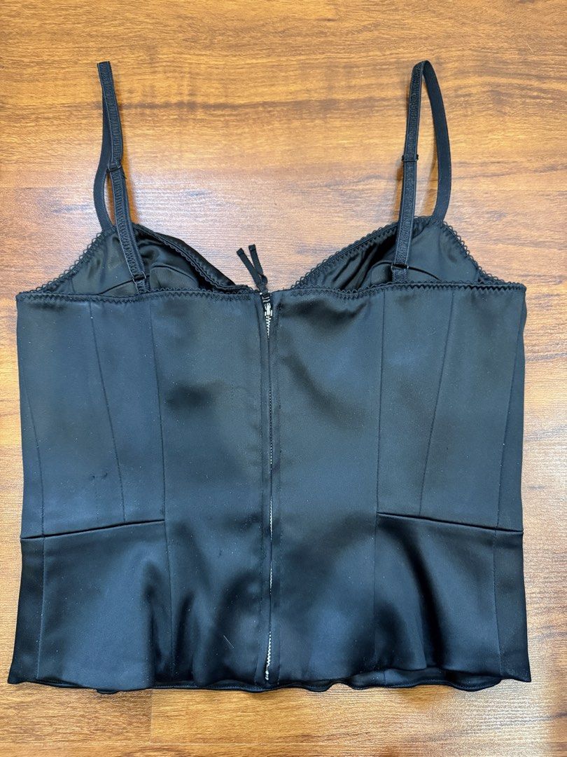 Aritzia - Wilfred Black Satin Corset Top (Category: Sleeveless) located in Quezon City. Submitted by shoppingwithj (Listing ID 1447192248, Image 2). Description: - Wilfred black satin corset top - Features delicate lace trim along the neckline - Adjustable straps for a perfect fit - Convenient zip closure at the back - Super flattering silhouette - Versatile styling: pairs beautifully with jeans or skirts.