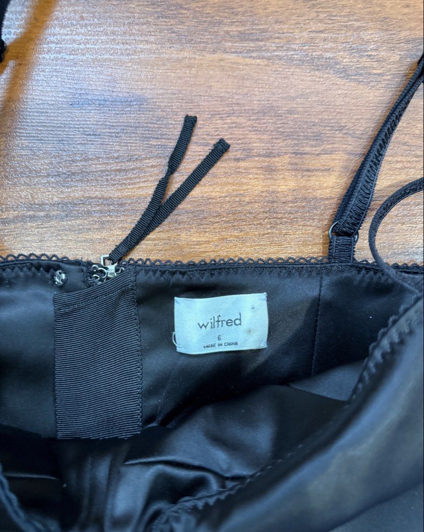 Aritzia - Wilfred Black Satin Corset Top (Category: Sleeveless) located in Quezon City. Submitted by shoppingwithj (Listing ID 1447192248, Image 3). Description: - Wilfred black satin corset top - Features delicate lace trim along the neckline - Adjustable straps for a perfect fit - Convenient zip closure at the back - Super flattering silhouette - Versatile styling: pairs beautifully with jeans or skirts.