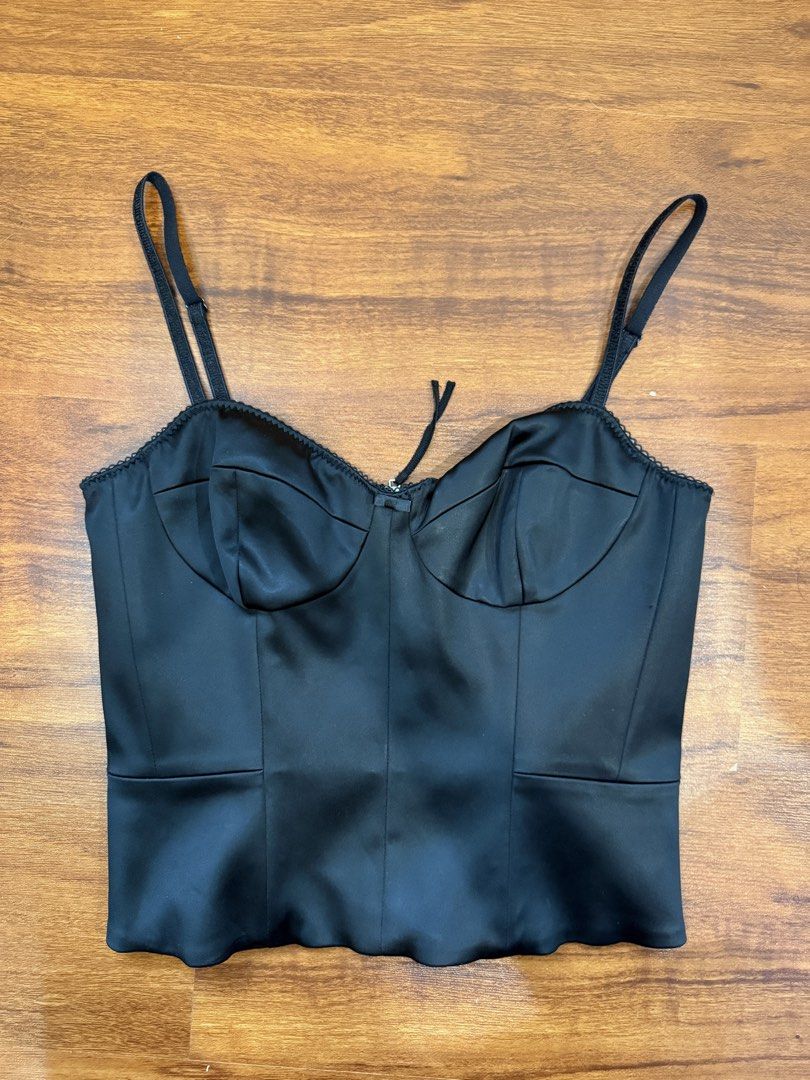 Aritzia - Wilfred Black Satin Corset Top (Category: Sleeveless) located in Quezon City. Submitted by shoppingwithj (Listing ID 1447192248, Image 1). Description: - Wilfred black satin corset top - Features delicate lace trim along the neckline - Adjustable straps for a perfect fit - Convenient zip closure at the back - Super flattering silhouette - Versatile styling: pairs beautifully with jeans or skirts.