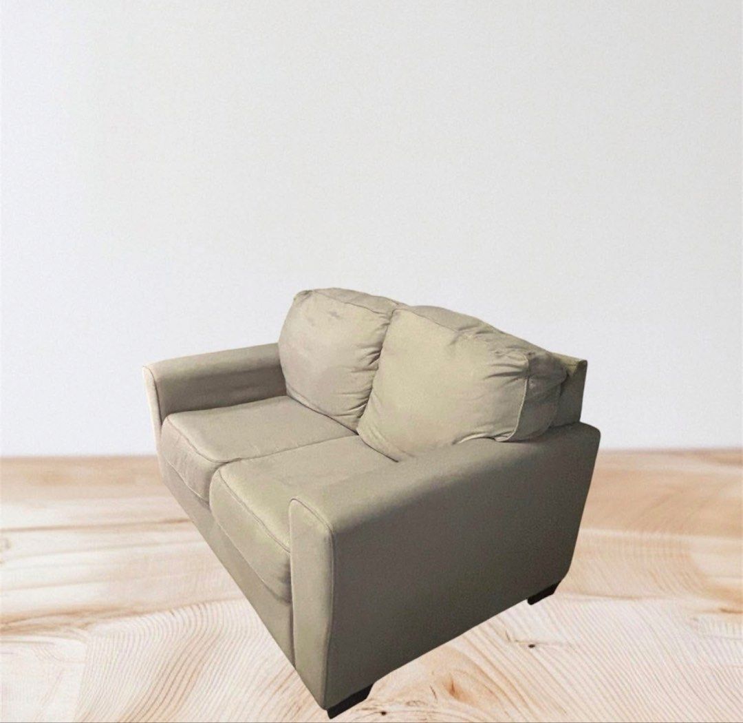 Ashley 2-Seater Sofa - Light Grey (Category: Sofas) located in Paranaque City. Submitted by buttonbabies (Listing ID 1447168156, Image 2). Description: - Comfortable 2-seater sofa - Light grey fabric - Dimensions: 160cm (L) x 95cm (W) x 82cm (H) - Minor wear on armrest, as pictured - Ideal for smaller living spaces - Plenty of life left!.