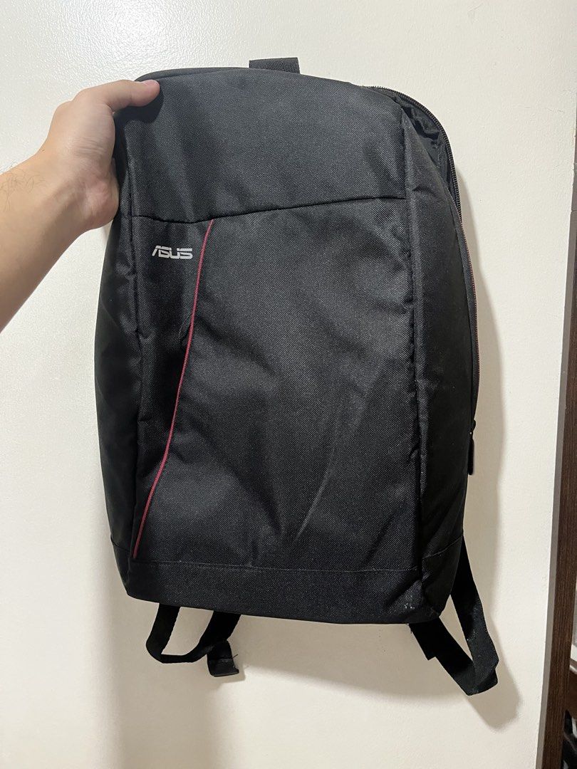 ASUS Black Backpack (Category: Backpacks) located in Quezon City. Submitted by vans_online_store (Listing ID 1447120149, Image 1). Description: - Sleek black ASUS backpack - Eye-catching red accent line on front pocket - Padded straps for maximum comfort - Multiple compartments for organized storage - Ideal for laptops and daily essentials - Clean and simple, versatile design.