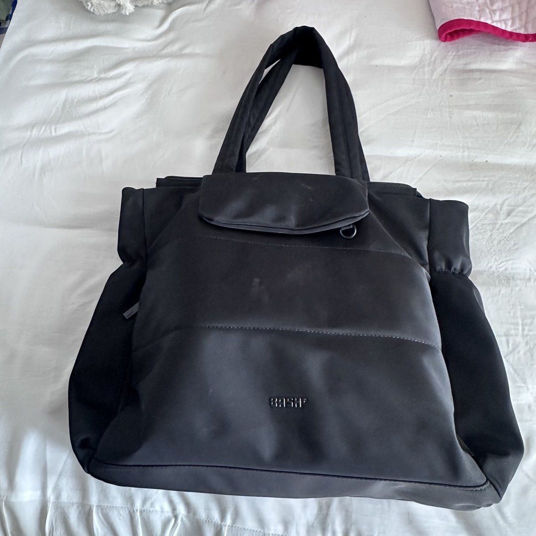 BASH Tote Bag Black (Category: Tote Bags) located in Porac. Submitted by declutter.dea (Listing ID 1447110677, Image 1). Description: - Stylish black tote bag - Secure zipper closure - Multiple interior pockets for excellent organization - Comfortable dual handles for carrying - Elegant metal clasp detail - Ideal for everyday use or travel rfs: not used as much anymore.