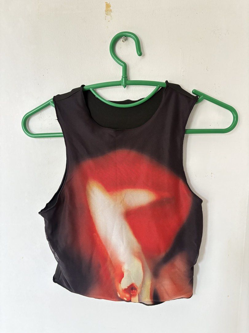 Black Graphic Print Sleeveless Tank Top (Category: Sleeveless) located in Bauan. Submitted by 131d_ (Listing ID 1447171645, Image 1). Description: - Black sleeveless tank top - Bold red and white graphic print - Lightweight fabric with a slight sheen .