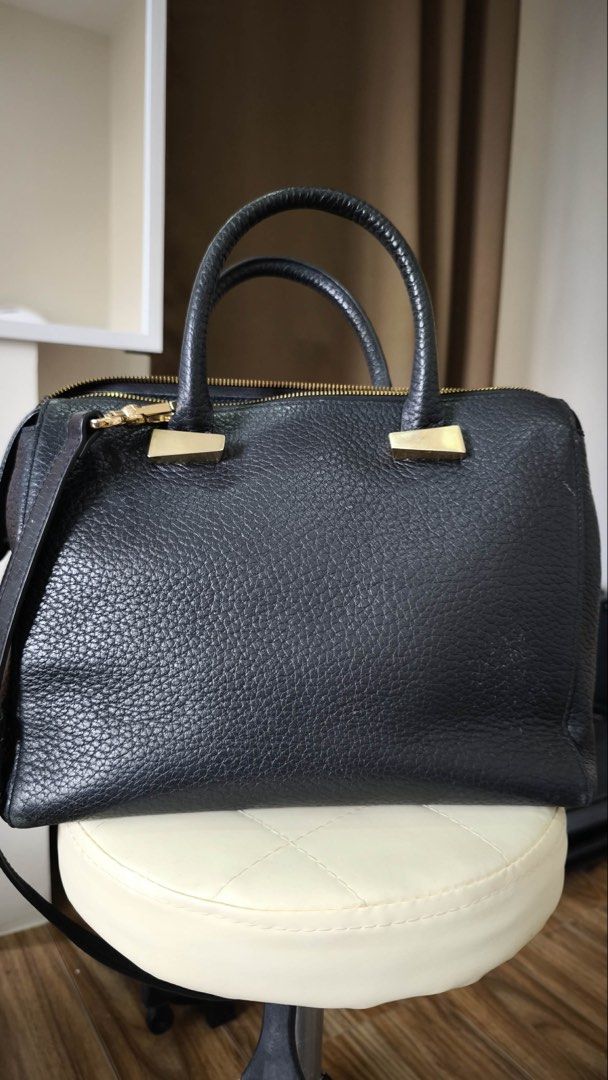 Black Leather Satchel Bag with Gold Hardware (Category: Luxury Bags & Wallets) located in Antipolo. Submitted by waco1313 (Listing ID 1447144157, Image 3). Description: - without strap - Stylish black pebbled leather satchel bag - Elegant gold bar embellishments on the front - Comfortable top handles - Includes a detachable shoulder strap for versatility - Secure zipper closure - All gold-tone hardware - Roomy interior for all your essentials - I