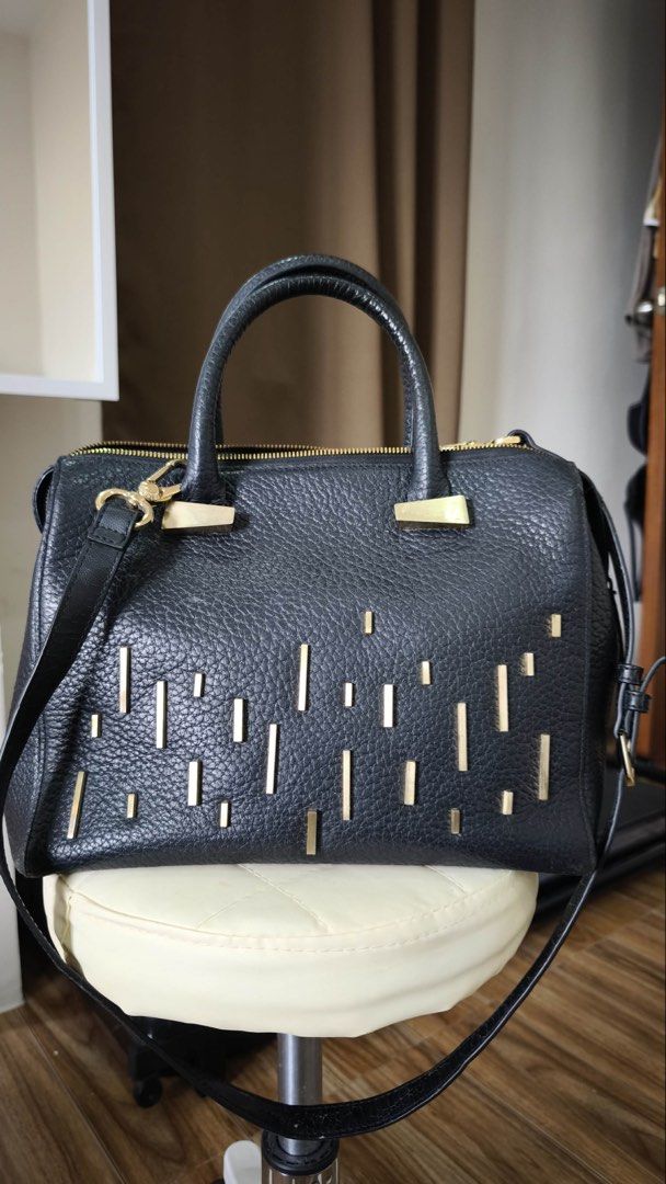 Black Leather Satchel Bag with Gold Hardware (Category: Luxury Bags & Wallets) located in Antipolo. Submitted by waco1313 (Listing ID 1447144157, Image 1). Description: - without strap - Stylish black pebbled leather satchel bag - Elegant gold bar embellishments on the front - Comfortable top handles - Includes a detachable shoulder strap for versatility - Secure zipper closure - All gold-tone hardware - Roomy interior for all your essentials - I