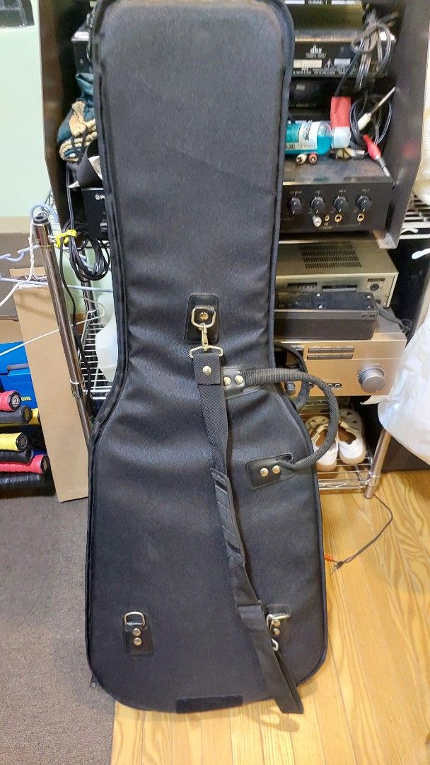 Guitar Gig Bag (Category: Musical Instruments) located in Baliuag. Submitted by papa.gardz (Listing ID 1447164900, Image 3). Description: - Black padded gig bag for guitars. - Main compartment for instrument. - Smaller front pocket for accessories. - Sturdy handle for easy carrying. - Detachable shoulder strap included. - Soft interior lining protects your guitar. - Ideal for both transport and storage..