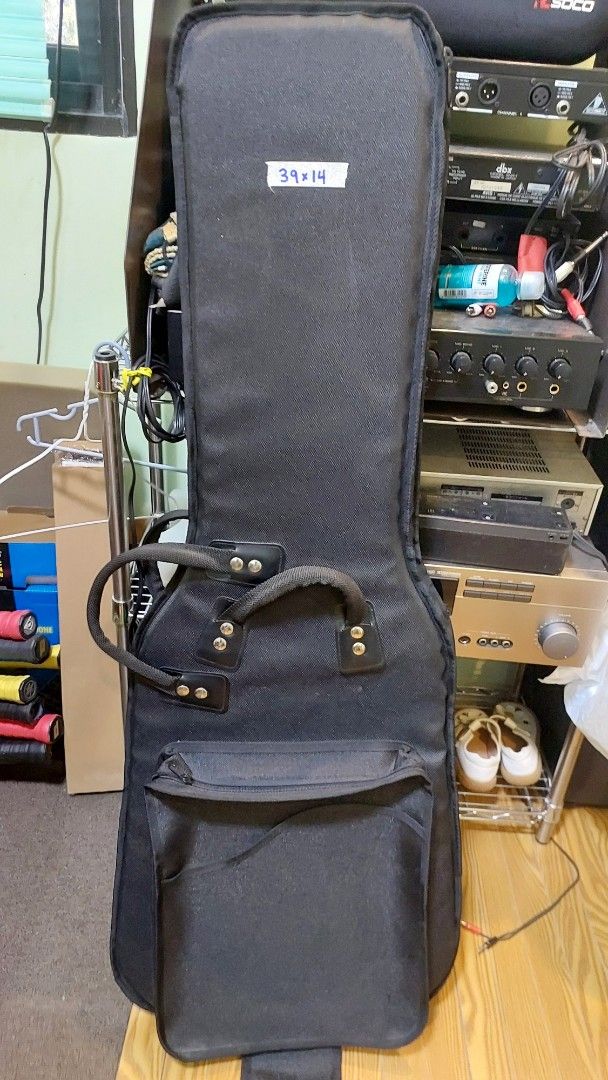 Guitar Gig Bag (Category: Musical Instruments) located in Baliuag. Submitted by papa.gardz (Listing ID 1447164900, Image 1). Description: - Black padded gig bag for guitars. - Main compartment for instrument. - Smaller front pocket for accessories. - Sturdy handle for easy carrying. - Detachable shoulder strap included. - Soft interior lining protects your guitar. - Ideal for both transport and storage..