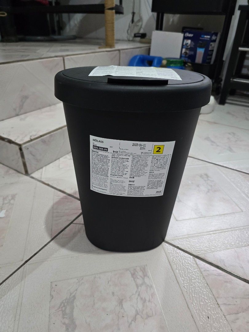 Black Round Trash Can with Hinged Lid (Category: Storage Boxes & Baskets) located in Makati City. Submitted by shopaholicsgallery (Listing ID 1447124162, Image 1). Description: - Sleek black round trash can - Convenient hinged lid for easy access - Versatile design, suitable for any room - Durable and sturdy plastic construction - Features labels on the side - Dimensions: H35cm x W25cm × D20cm - Brand: IKEA.