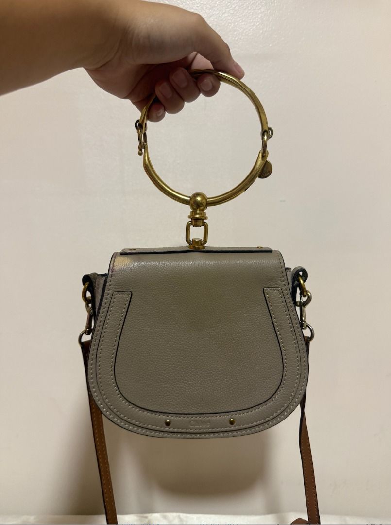 Chloe Nile Bracelet Bag Grey Leather (Category: Luxury Bags & Wallets) located in Imus. Submitted by allycasul (Listing ID 1447172705, Image 2). Description: - Authentic Chloe bag in grey leather - Features the iconic bracelet handle - Can be worn as a crossbody bag - Elegant gold hardware - Secure magnetic snap closure - Interior compartment for essentials - Ideal for both daily use and evening events.
