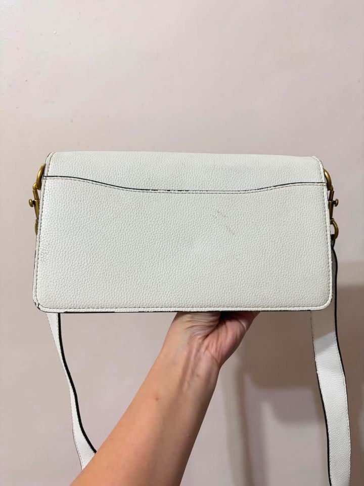 Coach Tabby Shoulder Bag White Pebble Leather (Category: Luxury Bags & Wallets) located in Manila. Submitted by neri_declutters (Listing ID 1447124309, Image 2). Description: - White Coach Tabby bag - Pebble leather exterior with gold hardware - Tan interior - Includes crossbody strap - Minor marks on back and edges - Interior is clean - Great for everyday use.