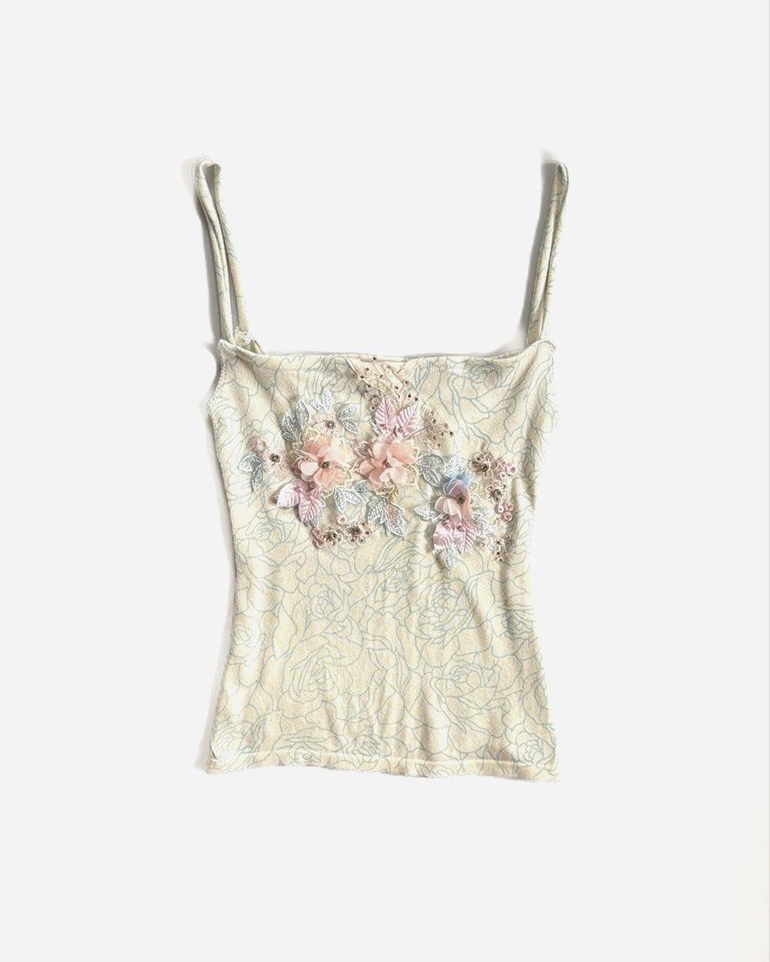 Cream Floral Embellished Cami Top (Category: Sleeveless) located in Manila. Submitted by secondtimearound__ (Listing ID 1447223582, Image 1). Description: - Cream cami top with a delicate floral pattern. - Features charming 3D floral embellishments on the front. - Adjustable spaghetti straps for a perfect fit. - Made from soft and stretchy material for comfort. - Versatile piece: great for layering or wearing solo..