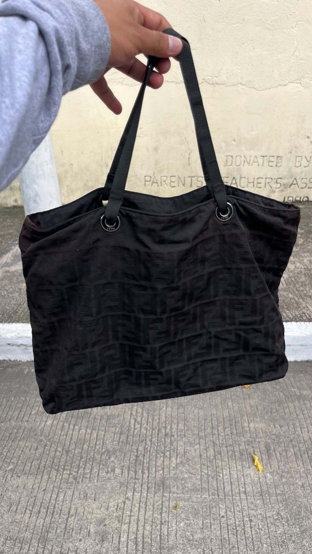 Fendi Zucca Pattern Tote Bag (Category: Luxury Bags & Wallets) located in Polomolok. Submitted by warmfire.3185dd (Listing ID 1447290490, Image 1). Description: - Authentic black Fendi tote bag - Features the classic Zucca pattern - Spacious interior for all your essentials - Comfortable dual shoulder straps - Secure zipper closure with Fendi branded pull - Includes authenticity tag - Ideal for everyday use.