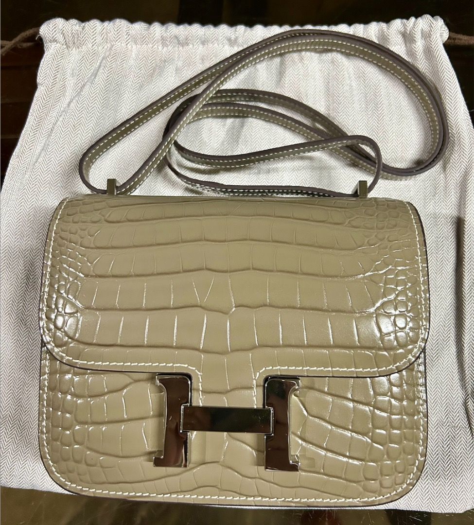 Hermes Constance Bag (Category: Luxury Bags & Wallets) located in Caloocan City. Submitted by hermes_evangelista (Listing ID 1447222694, Image 1). Description: A classic Hermes bag that can be as hard to find as the Birkin or Kelly bag. This pre-loved Hermes Constance in Gris Tourterelle, made of Crocodile Niloticus leather (with the symbol used is a double dot (··) next to the Hermès logo) exudes luxury. This chameleon-like color transforms from
