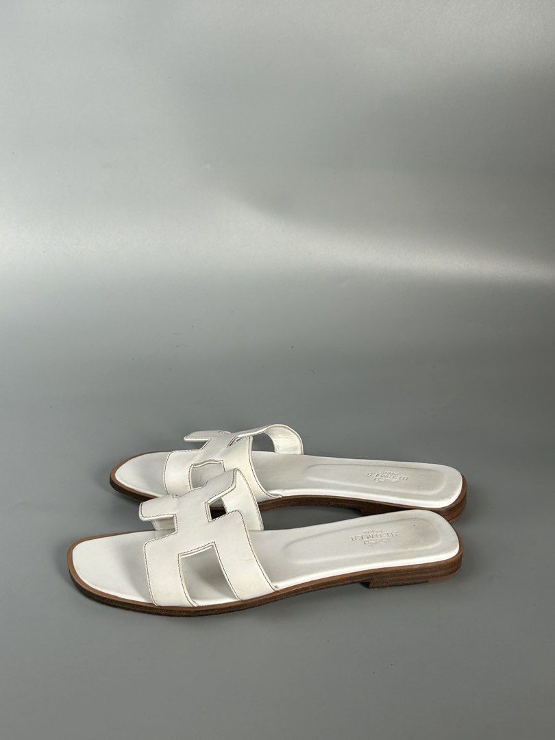 Hermes Oran Sandals White Leather Size 38 (Category: Sneakers & Footwear) located in Tacloban City. Submitted by houseofluxury.co (Listing ID 1447161484, Image 2). Description: - Authentic Hermes Oran Sandals - Color: White Leather - Size: 38 - Made in Italy - Classic 'H' Design - Provided dustbag inclusion - Ideal for everyday wear.