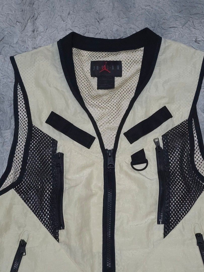 Jordan Utility Vest Tan Black Mesh Pockets (Category: Vests) located in Abulug. Submitted by humanwhosellthings (Listing ID 1447232108, Image 3). Description: - Jordan utility vest in tan and black. - 20W x 23L - Like New Condition - Cut washtag lang issue - Features multiple pockets, some with mesh detailing. - Zipper closure for secure fit. - Ideal for ample storage and adding a stylish element to your outfit. - Perfect for layering over other 