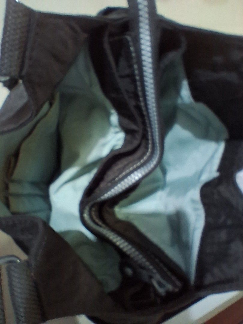 Kipling Dark Brown Nylon hand bag with Monkey Charm (Category: Shoulder Bags) located in Angeles City. Submitted by anneps (Listing ID 1447222192, Image 2). Description: - Dark brown Kipling hand bag - Made from durable nylon material - Secure zip closure - Multiple interior pockets for organization - Includes the signature Kipling monkey charm - Spacious design, ideal for everyday use.