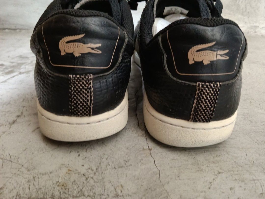 Lacoste Black Leather Sneakers (Category: Sneakers) located in Paranaque City. Submitted by 27rcd (Listing ID 1447203722, Image 2). Description: Black leather sneakers from Lacoste. Classic low-top style with lace-up closure. Features the iconic crocodile logo on the side and heel. Versatile pair for everyday wear. Some signs of wear on the soles and leather..