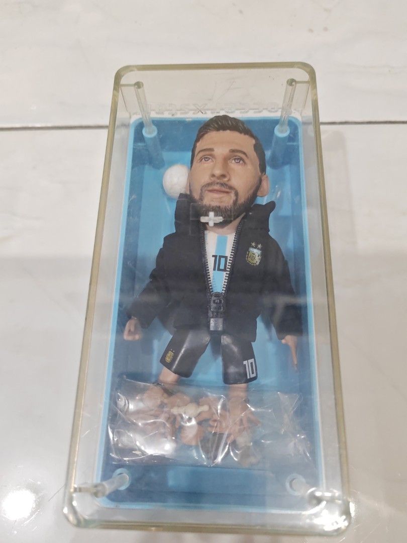 Lionel Messi Bobblehead Action Figure with Accessories (Category: Toys & Games) located in Tawau. Submitted by csp2363 (Listing ID 1447212989, Image 3). Description: - Lionel Messi bobblehead figure - Features Messi in his iconic Argentina kit - Comes with interchangeable extra hands - Includes a miniature football accessory - Displayed in a clear protective case - An essential collectible for any football enthusiast cod at tawau sabah, postage c