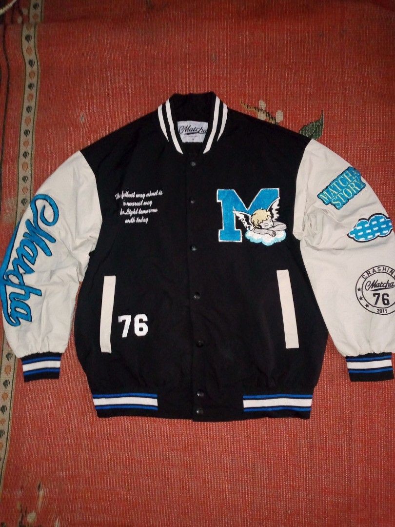 Matcha Story Varsity Jacket M Cherub Cloud Design (Category: Coats, Jackets and Outerwear) located in Manila. Submitted by milyonaryung_gipit (Listing ID 1447110063, Image 1). Description: - Brand: Matcha Story - Style: Black and white varsity jacket - Design: Large 'M' with cherub and cloud graphic on front - Details: 'Matcha Story' and '76' on sleeves and front - Size: S - Occasion: Great for casual wear.