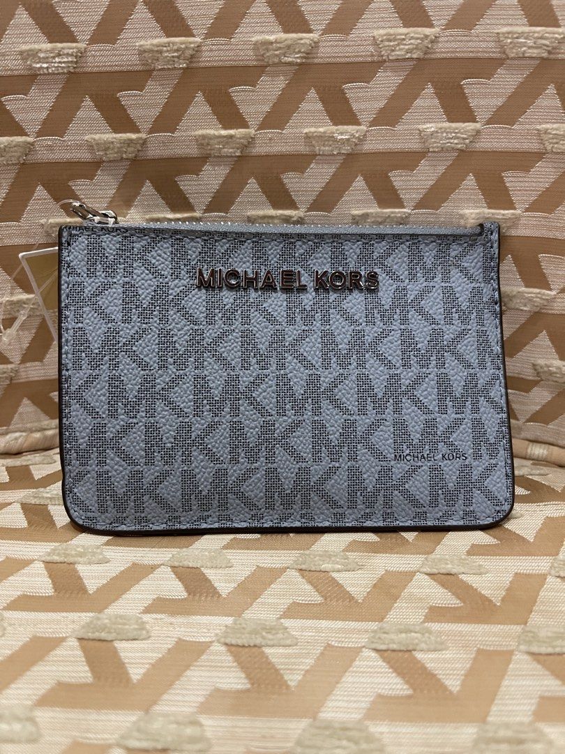 Michael Kors Card Holder Pouch Navy (Category: Wallets & Card holders) located in Davao. Submitted by giftopia (Listing ID 1447181880, Image 1). Description: - Authentic Michael Kors card holder - Signature navy and light blue MK all-over print - Zippered compartment for secure storage - Clear ID window on the back for easy access - Comes with original tag and card - Perfect for organizing cards and cash.