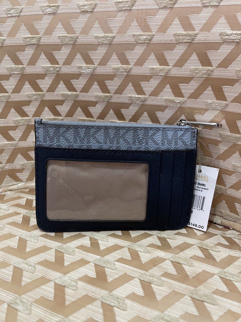 Michael Kors Card Holder Pouch Navy (Category: Wallets & Card holders) located in Davao. Submitted by giftopia (Listing ID 1447181880, Image 2). Description: - Authentic Michael Kors card holder - Signature navy and light blue MK all-over print - Zippered compartment for secure storage - Clear ID window on the back for easy access - Comes with original tag and card - Perfect for organizing cards and cash.