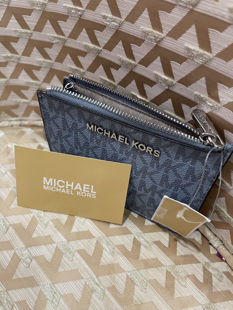 Michael Kors Card Holder Pouch Navy (Category: Wallets & Card holders) located in Davao. Submitted by giftopia (Listing ID 1447181880, Image 3). Description: - Authentic Michael Kors card holder - Signature navy and light blue MK all-over print - Zippered compartment for secure storage - Clear ID window on the back for easy access - Comes with original tag and card - Perfect for organizing cards and cash.