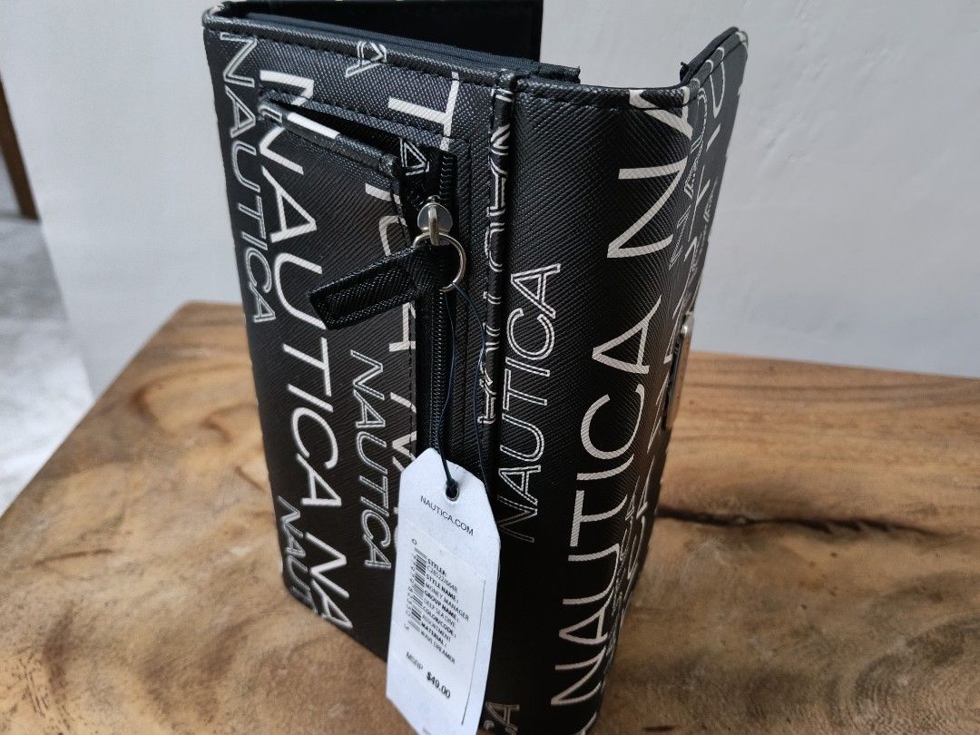 Nautica Black White Logo Print Wallet (Category: Wallets & Card holders) located in Paranaque City. Submitted by 27rcd (Listing ID 1447207557, Image 2). Description: Nautica wallet with all-over logo print. Black with white lettering. Has a zip pocket on the side. Interior has card slots and a button closure. Comes with tags attached. Great for everyday use. 8"W x 4.5" H.