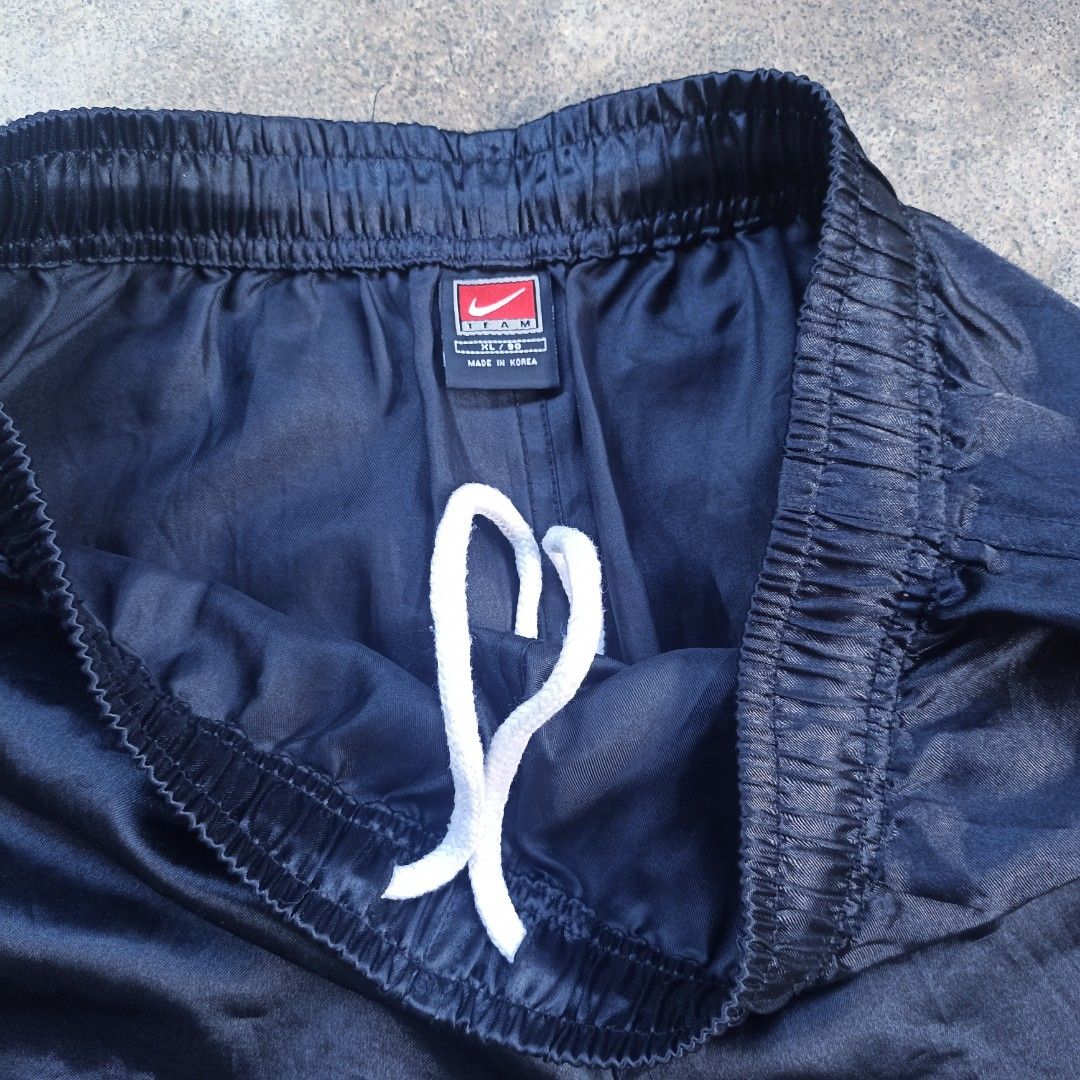 VINTAGE NIKE (Category: Shorts) located in Davao. Submitted by anythin6 (Listing ID 1447134325, Image 2). Description: - Navy blue Nike basketball shorts - See the number '2' for small issue - Classic Nike swoosh on the right leg - Elastic waistband with a white drawstring - Ideal for basketball, sports, or everyday casual wear.