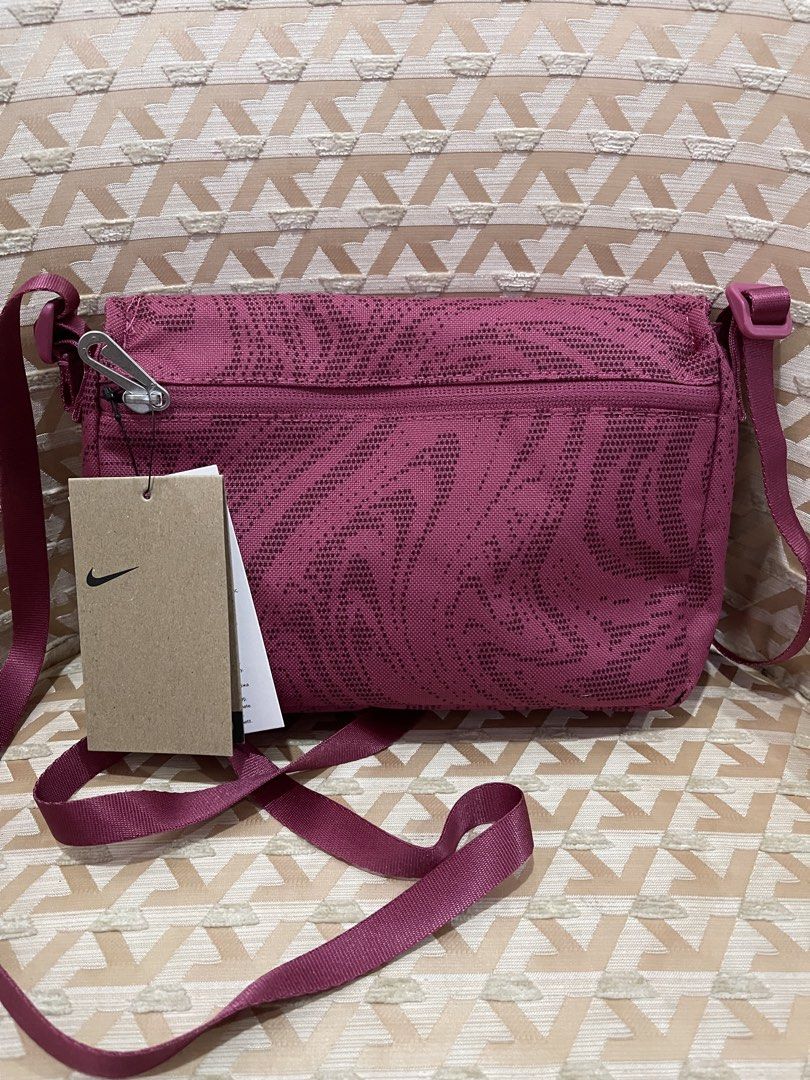 Nike Pink Patterned Crossbody Bag with Black Logo (Category: Cross-body Bags) located in Davao. Submitted by giftopia (Listing ID 1447181703, Image 3). Description: - Pink Nike crossbody bag - Features a cool all-over pattern - Black Nike logo on the front - Zippered back pocket - Main compartment with magnetic closure - Adjustable strap - Comes with original tags.
